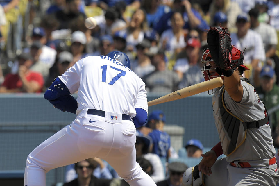 Los Angeles Dodgers' Miguel Vargas, left, ducks out of the way of a wild pitch that allowed Will Smith to score as St. Louis Cardinals catcher Willson Contreras misses the ball during the fifth inning of a baseball game Sunday, April 30, 2023, in Los Angeles. (AP Photo/Mark J. Terrill)