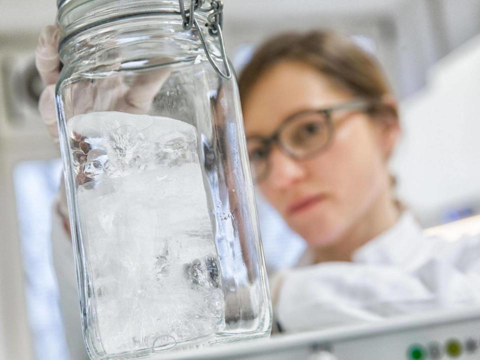 AWI scientist Julia Gutermann analysing an Arctic sea ice core for microplastic particles in a lab at the AWI Helgoland (Tristan Vankann)