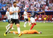 <p>Kylian Mbappe runs to salute the crowd following his brace that sends Argentina tumbling out of the World Cup </p>