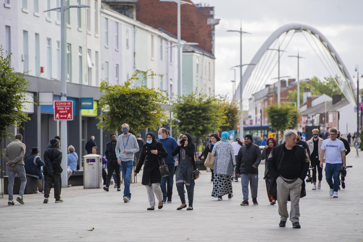 BOLTON, ENGLAND - SEPTEMBER 09: Members of the public wear face masks in Bolton town centre as Coronavirus restrictions are tightened in the area on September 09, 2020 in Bolton, England. (Photo by Anthony Devlin/Getty Images)