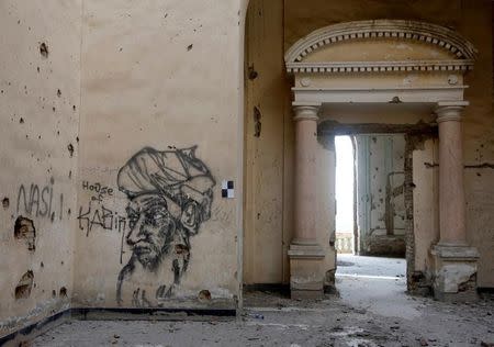 Graffiti is seen a wall of the Darul Aman palace in Kabul, Afghanistan, June 5, 2016. REUTERS/Omar Sobhani