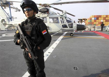 A Chinese commando guards the helipad of the Chinese frigate Yancheng docked at the port of Limassol January 4, 2014. REUTERS/Andreas Manolis