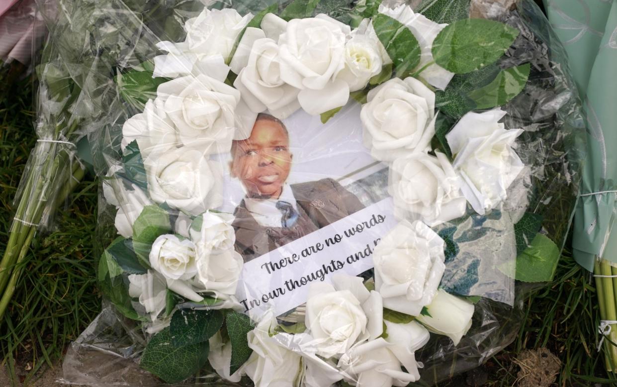 A wreath with a photograph of Daniel Anjorin was among the floral tributes left at the scene of his death