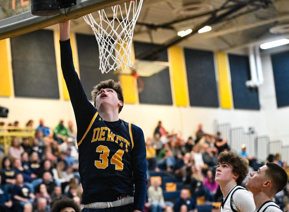 Garrett Grewe of DeWitt scores against Grand Ledge, Friday, Dec. 15, 2023, at Grand Ledge. DeWitt won 60-50.