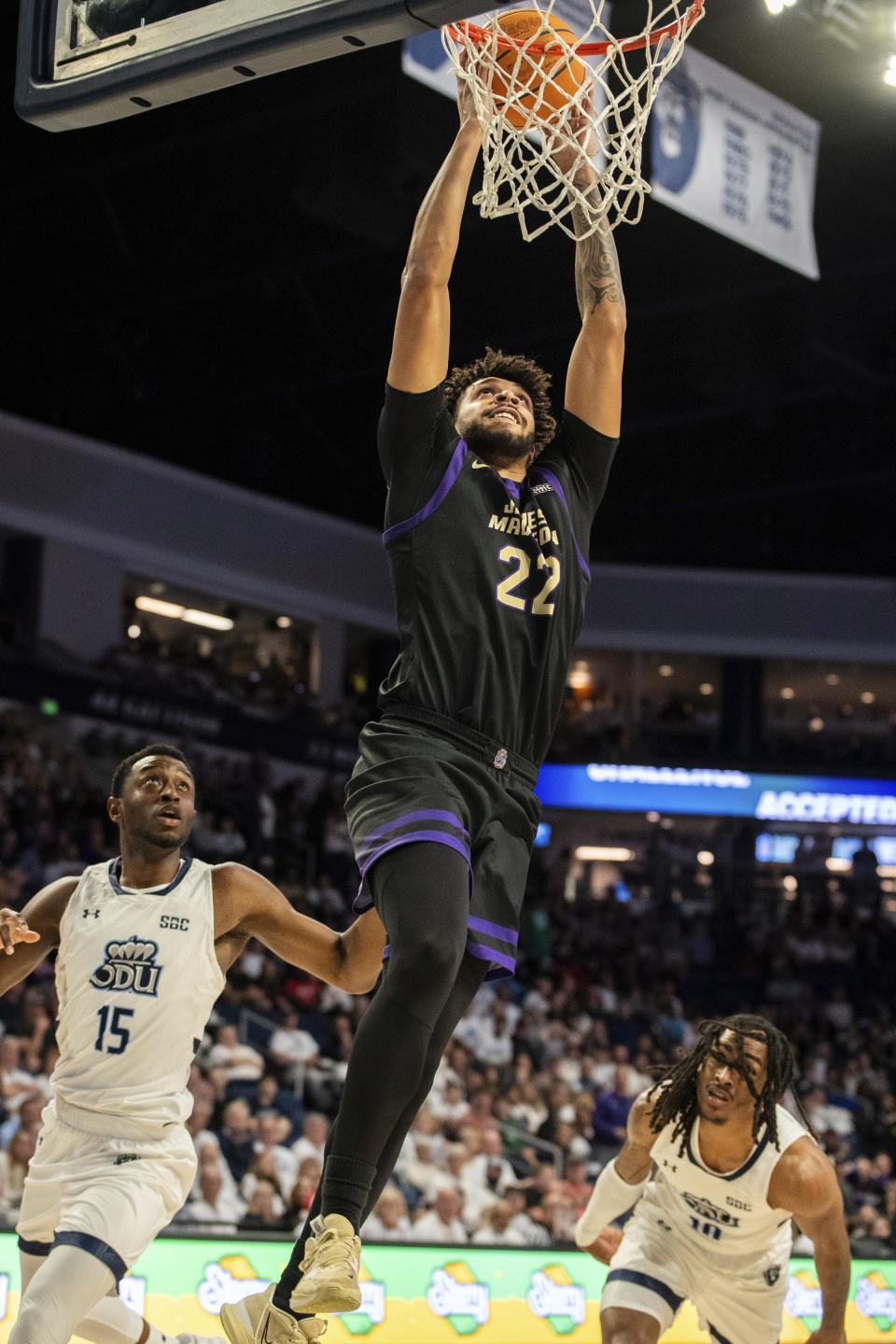 James Madison forward Julien Wooden (22) dunks against Old Dominion guards R.J. Blakney (15) and Williams (10) during the first half of an NCAA college basketball game Saturday, Dec. 9, 2023, in Norfolk, Va. (AP Photo/Mike Caudill)
