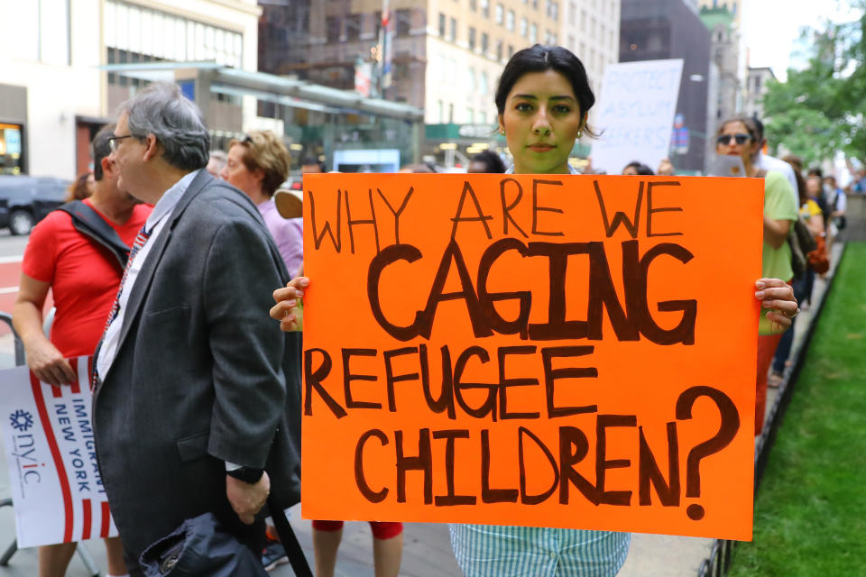 Ashley Portillo holds up a sign addressing immigration policy at the protest in New York City on June 20, 2018. (Photo: Gordon Donovan/Yahoo News)