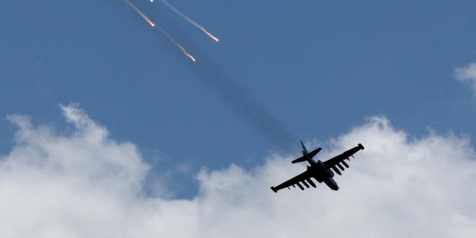 A Ukrainian Air Force Su-25 jet flying low in the sky.