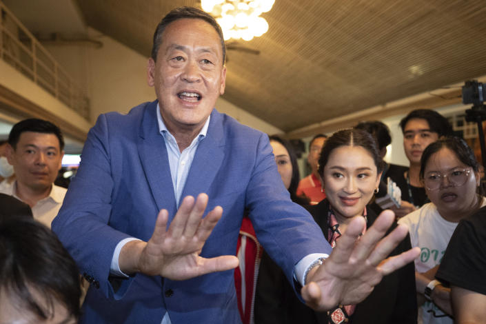 Pheu Thai Party's prime ministerial candidates Srettha Thavisin, left, and Paetongtarn Shinawatra, leave after a press conference at Pheu Thai headquarter in Bangkok, Thailand, Sunday, May 14, 2023. Thailand's main opposition party took an early lead in a vote count from Sunday's general election, touted as a pivotal chance for change nine years after incumbent Prime Minister Prayuth Chan-ocha first came to power in a 2014 coup. (AP Photo/Wason Wanichakorn)