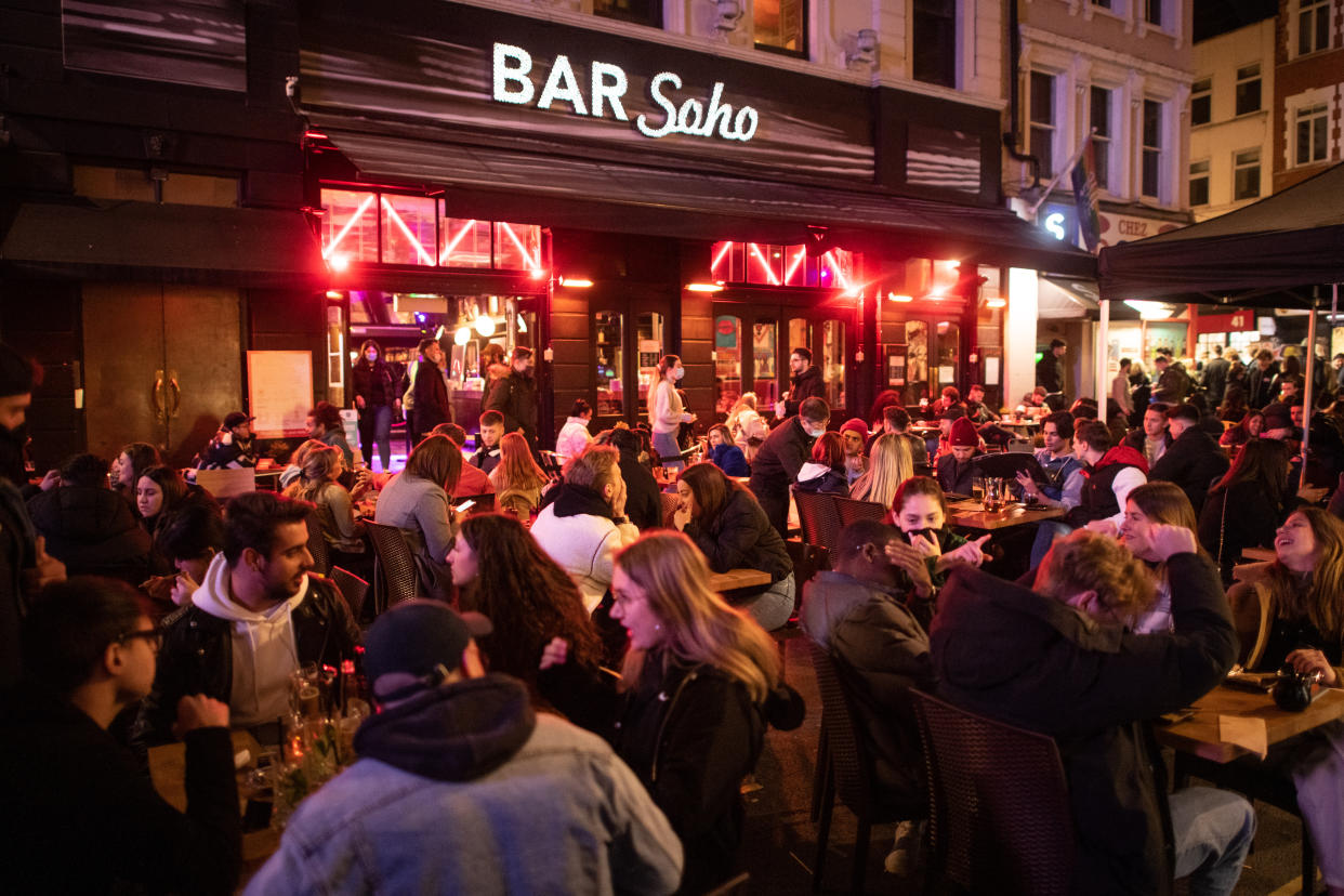 People gather in Soho, London, where streets were closed to traffic as bars and restaurants opened for outside eating and drinking, as lockdown measures are eased across the UK. Picture date: Tuesday April 13, 2021. Photo credit should read: Matt Crossick/Empics