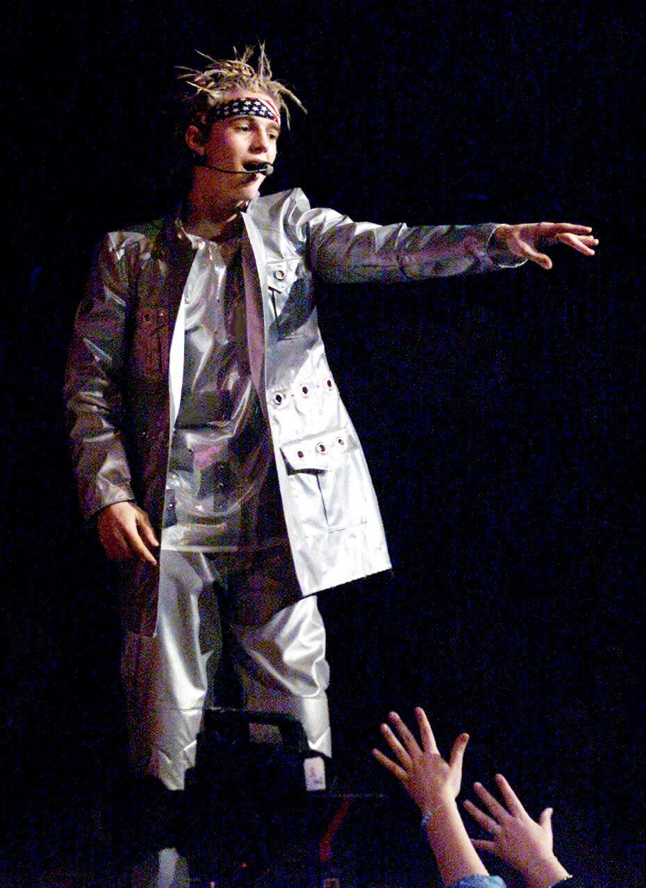 Just out of reach of his fans, 14-year-old pop star Aaron Carter sings to the crowd at the Gaylord Entertainment Center in Nashville on March 10, 2002.