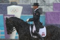 LONDON, ENGLAND - AUGUST 02: David Marcus of Canada riding Capital during a rain shower in the Dressage Grand Prix on Day 6 of the London 2012 Olympic Games at Greenwich Park on August 2, 2012 in London, England. (Photo by Alex Livesey/Getty Images)