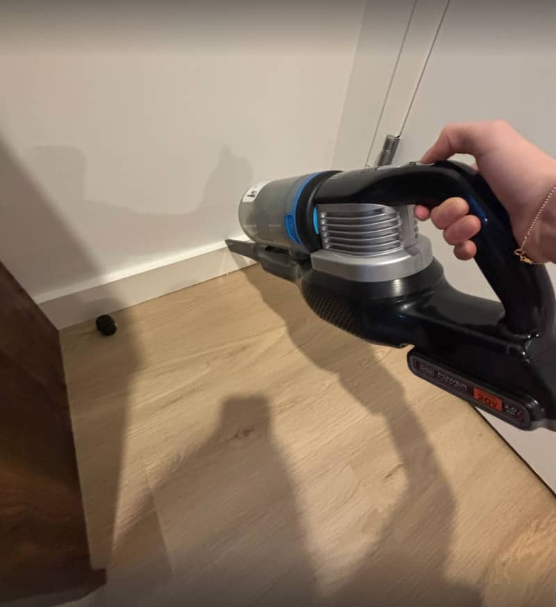 someone using the BLACK+DECKER POWERSERIES Extreme MAX Cordless Stick Vacuum at home