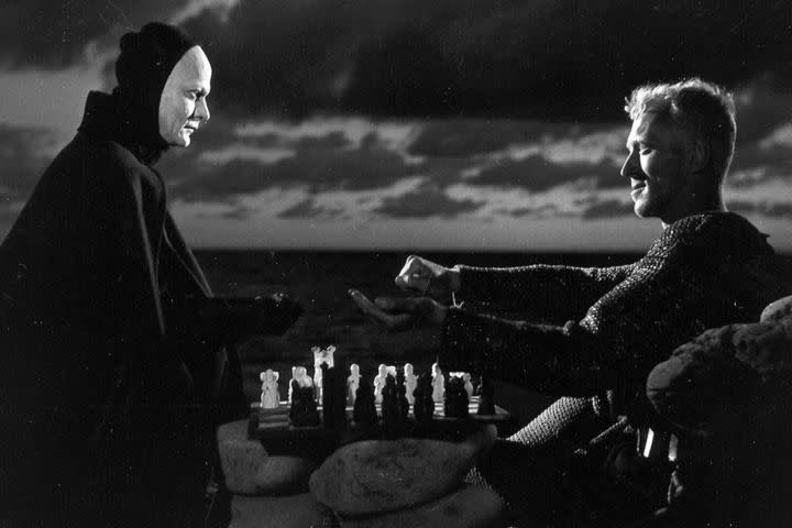 Max von Sydow and Bengt Ekerot looking at each other with a chess board between them in The Seventh Seal (1957).