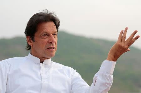 Pakistani opposition politician Imran Khan speaks with party leaders at his home in Bani Gala, outside Islamabad, Pakistan October 30, 2016. REUTERS/Caren Firouz