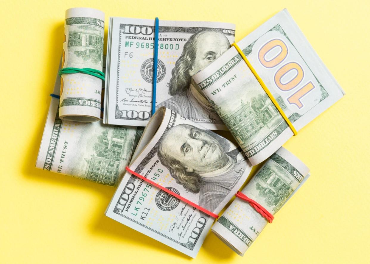 An image of money on a yellow background.