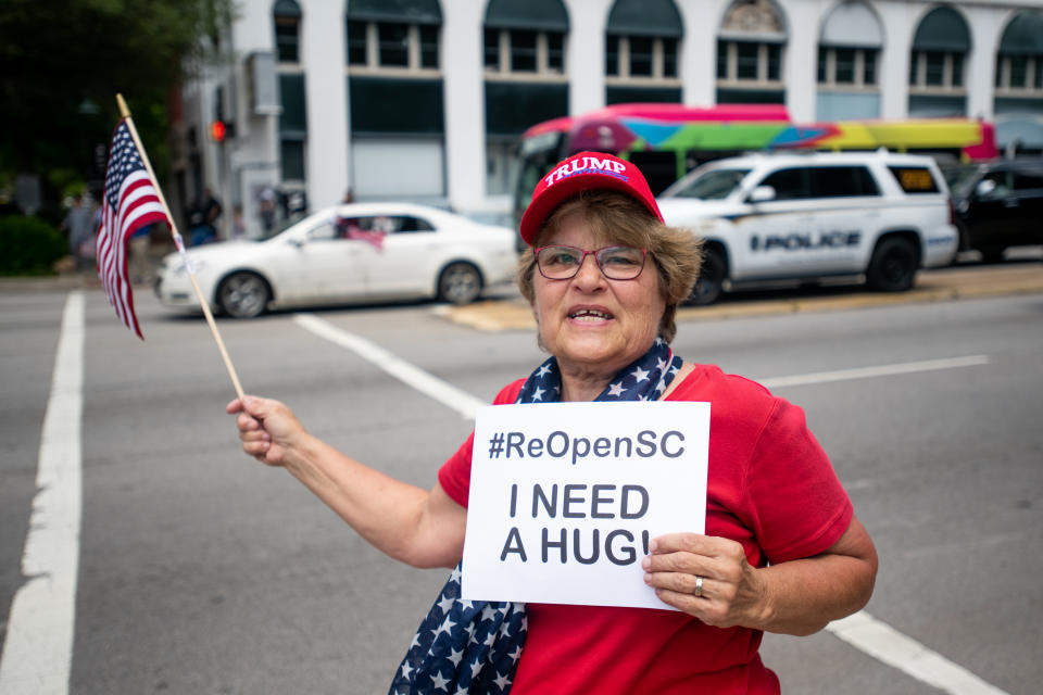 A woman protests against government closures of non-essential businesses due to the coronavirus on April 24, 2020 in Columbia, South Carolina. Although the state has allowed some non-essential businesses to re-open, restaurants, barber shops, massage therapists, entertainment venues and others remained closed by state order. (Photo by Sean Rayford/Getty Images)