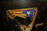A man holds an "estelada" or independence flag during a protest in Barcelona, Spain, Thursday, Oct. 17, 2019. Catalonia's separatist leader vowed Thursday to hold a new vote to secede from Spain in less than two years as the embattled northeastern region grapples with a wave of violence that has tarnished a movement proud of its peaceful activism. (AP Photo/Joan Mateu)