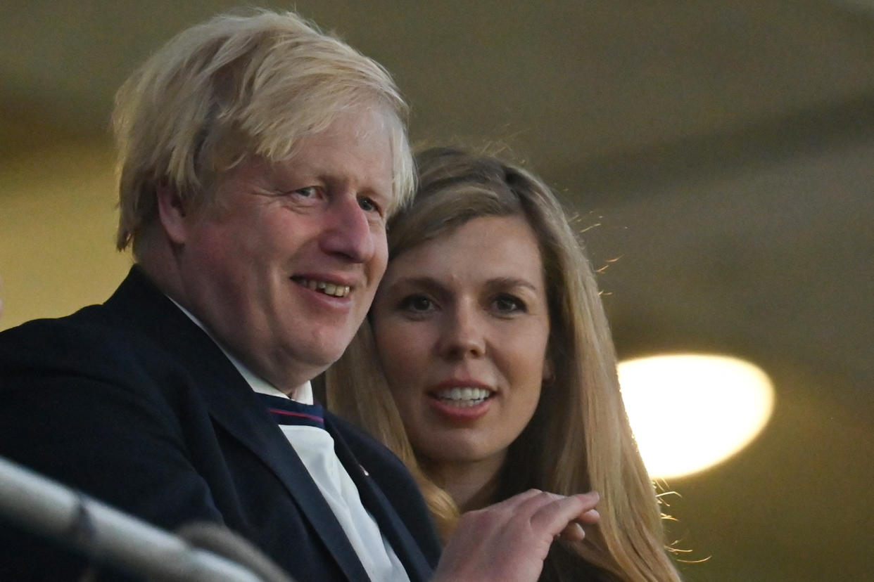 UK Prime Minister Boris Johnson (L) and his spouse Carrie (R) celebrate the win during the UEFA EURO 2020 semi-final football match between England and Denmark at Wembley Stadium in London on July 7, 2021. (Photo by JUSTIN TALLIS / POOL / AFP) (Photo by JUSTIN TALLIS/POOL/AFP via Getty Images)
