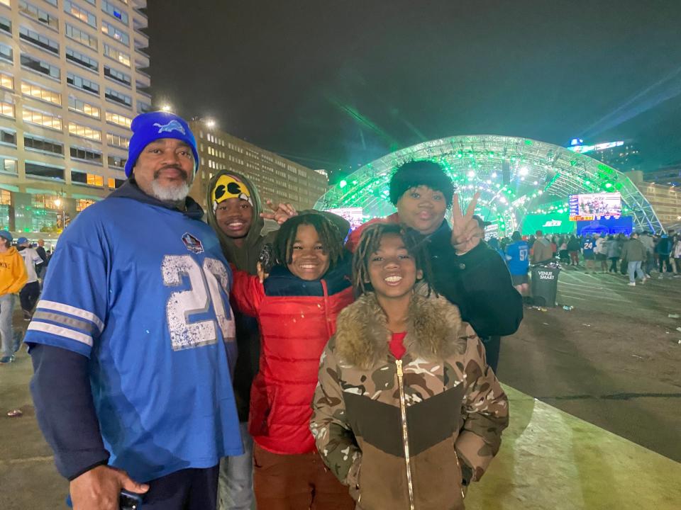 Charles Bouyer, 56, of Detroit, left, smiles Friday at the NFL draft in Detroit, along with his family, Barack, 15; Na’Seer, 12; Glenn, 10; and Icyy, 16.