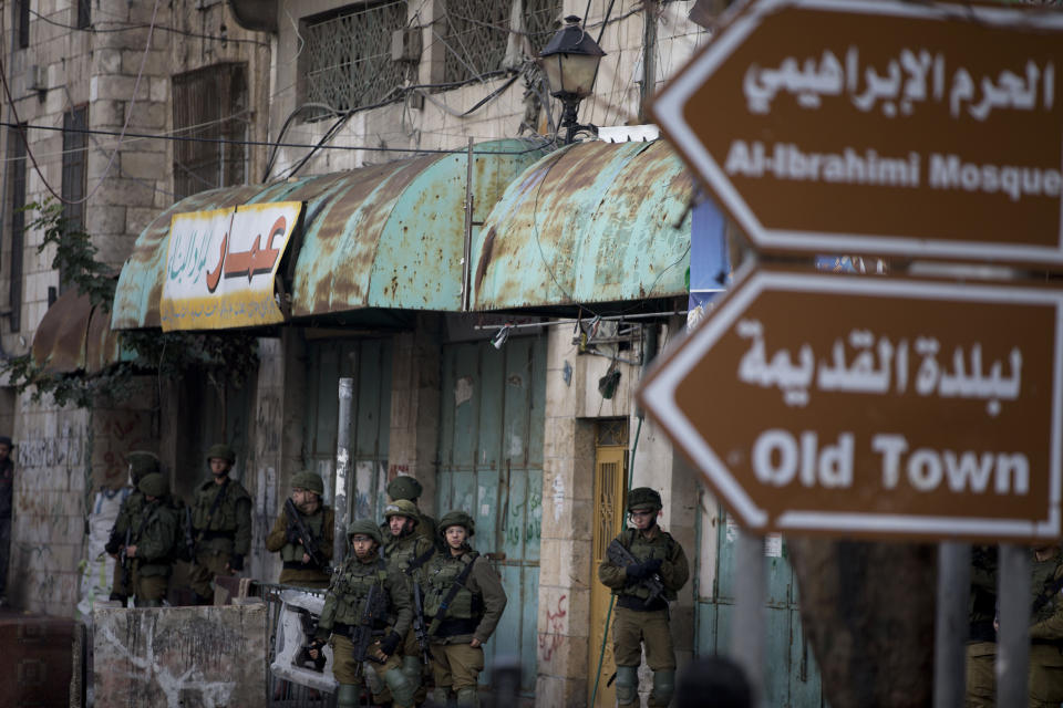 Israeli troops take their position during clashes with Palestinian demonstrators during a protest over Israeli settlement activity Monday, Dec. 9, 2019, in the West Bank city of Hebron. (AP Photo/Majdi Mohammed)