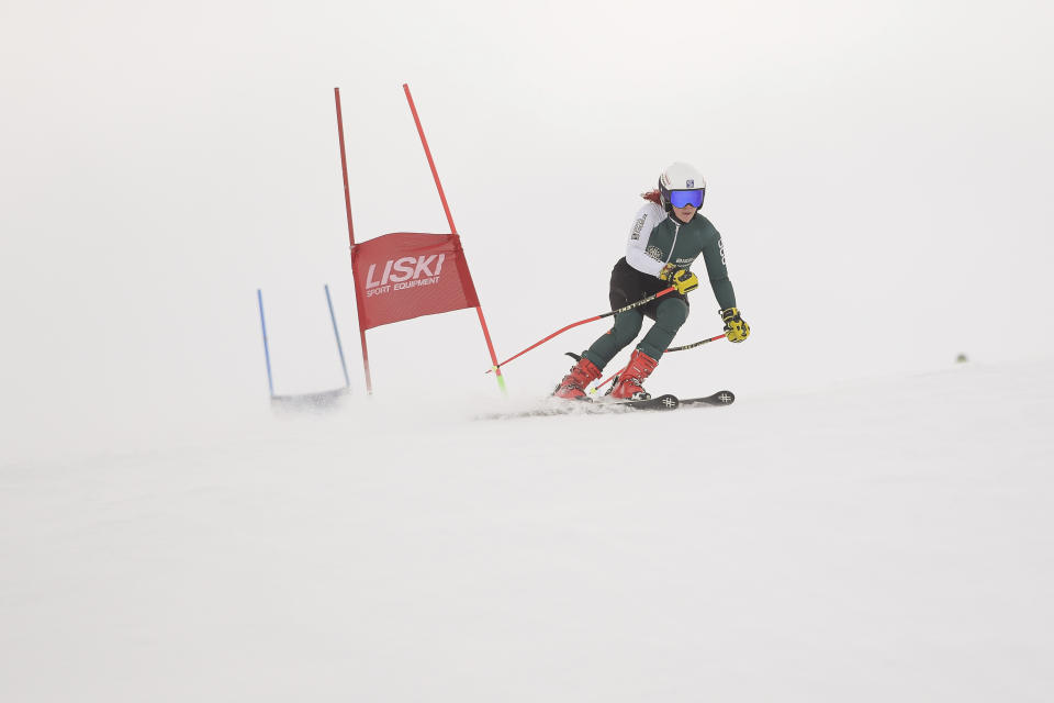 Kiana Kryeziu speeds down the course during training at the Arxhena Ski center in Dragas, Kosovo on Saturday, Jan. 22, 2022. The 17-year-old Kryeziu is the first female athlete from Kosovo at the Olympic Winter Games after she met the required standards, with the last races held in Italy. (AP Photo/Visar Kryeziu)