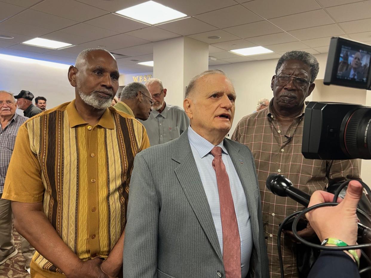 Bryant Middleton, center, talks to reporters after the Senate vote. Middleton was held at Dozier 1959 - 1961. On his left is Ralph Freeman, held at Dozier in 1972. To Middleton's right is Richard Huntley, held between 1957 - 1959.