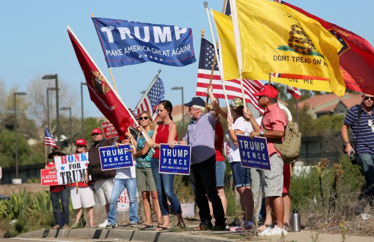 Demonstrators hold signs in support of President elect Donald Trump outside of Camp Pendleton in Oceanside, California, U.S. November 11, 2016. (Photo: Sandy Huffaker/Reuters)