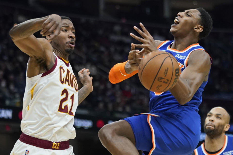 Cleveland Cavaliers' Ed Davis (21) knocks the ball loose from New York Knicks' RJ Barrett (9) in the second half of an NBA basketball game, Monday, Jan. 24, 2022, in Cleveland. The Cavaliers won 95-93. (AP Photo/Tony Dejak)