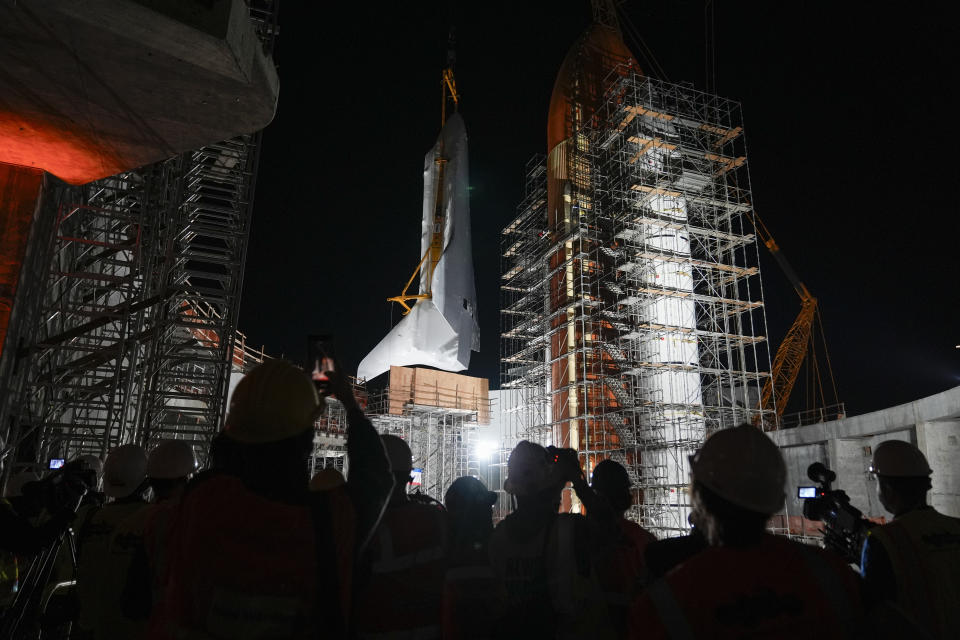 Space Shuttle Endeavour is lifted into the site of the future Samuel Oschin Air and Space Center on Tuesday, Jan. 30, 2024, in Los Angeles. (AP Photo/Ashley Landis)