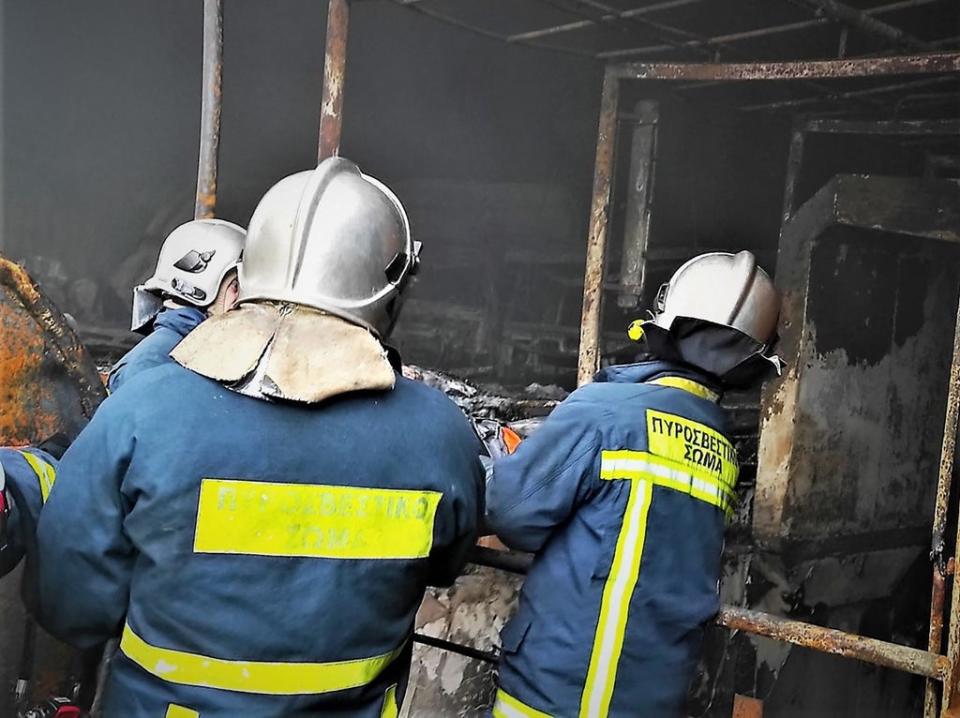 This handout picture released on Sunday shows firefighters transporting a body from the wreck (Hellenic Fire Service/AFP via Ge)