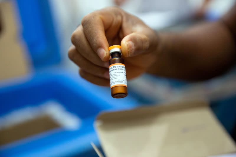 FILE PHOTO: A vial of measles vaccine is checked at a field logistics base run by Doctors Without Borders in the town of Boso-Manzi in Mongala province