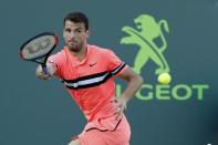 Mar 25, 2018; Key Biscayne, FL, USA; Grigor Dimitrov of Bulgaria hits a forehand against Jeremy Chardy of France (not pictured) on day six of the Miami Open at Tennis Center at Crandon Park. Chardy won 6-4, 6-4. Geoff Burke-USA TODAY Sports