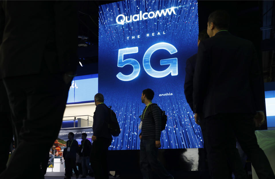 FILE- In this Jan. 9, 2019, file photo a sign advertises 5G at the Qualcomm booth at CES International in Las Vegas. A jury announced the verdict Friday, March 15, that Apple should pay $31 million in damages for infringing on patents for technology owned by mobile chip maker Qualcomm that helps iPhones quickly connect to the internet and extend their battery life. (AP Photo/John Locher, File)