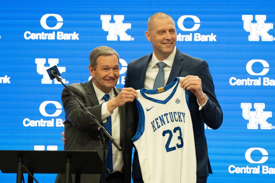 University of Kentucky Athletic Director Mitch Barnhart and new men’s basketball coach Mark Pope hold a new basketball jersey up during Pope’s press conference on Sunday, April 14, 2024.