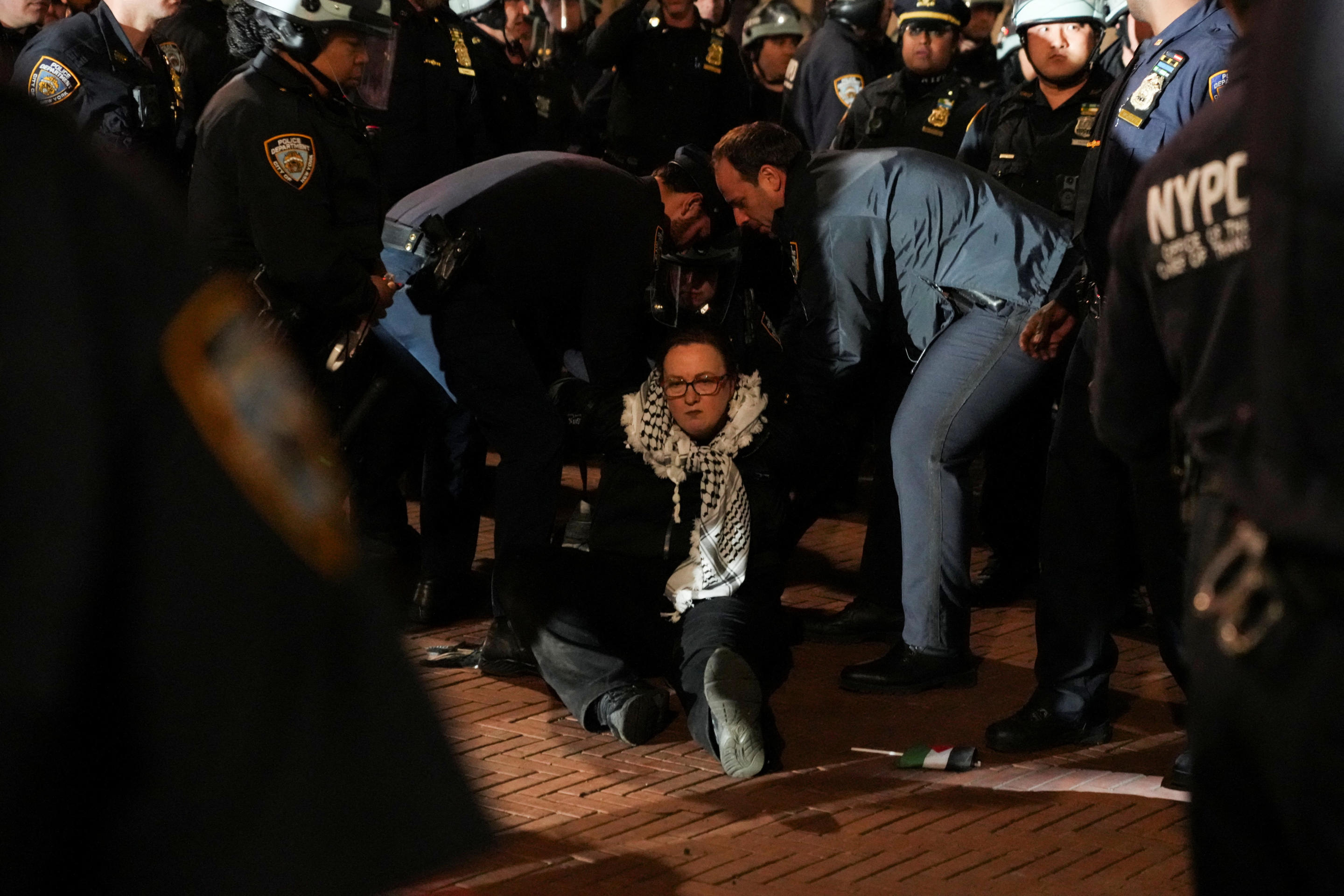 Police detain a protester as officers enter the campus of Columbia University.