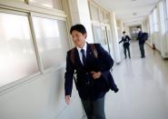 Ryoma Ouchi, an ace pitcher at Fukushima Commercial High School baseball team from Iitate, walks inside the school in Fukushima, Japan