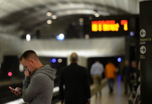 A man uses his smartphone in a metro station in Washington, DC. The Internet is set for a major upgrade in the coming week, but if all goes well, users won't even know it's happening