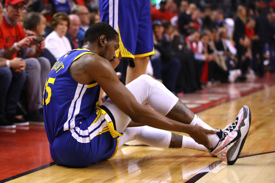 TORONTO, ONTARIO - JUNE 10:  Kevin Durant #35 of the Golden State Warriors reacts after sustaining an injury during the second quarter against the Toronto Raptors during Game Five of the 2019 NBA Finals at Scotiabank Arena on June 10, 2019 in Toronto, Canada. NOTE TO USER: User expressly acknowledges and agrees that, by downloading and or using this photograph, User is consenting to the terms and conditions of the Getty Images License Agreement. (Photo by Gregory Shamus/Getty Images)