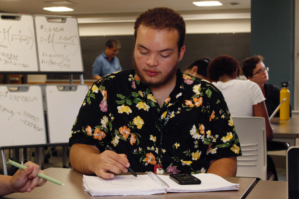 Angel Hope works on a math problem, part of an intense six-week summer bridge program for students of color and first-generation students at the University of Wisconsin, in Madison, Wis., July 27, 2022. Hundreds of thousands of recent graduates are heading to college this fall after spending more than half their high school careers dealing with the upheaval of a pandemic. Hope says he didn't feel ready for college after online classes in high school caused him fall behind but says the bridge classes made him feel more confident. (AP Photo/Carrie Antlfinger)