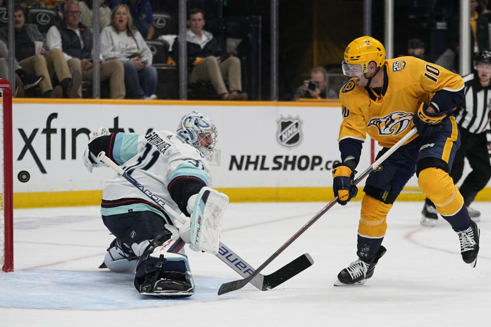 Nashville Predators center Colton Sissons (10) scores a goal past Seattle Kraken goaltender Philipp Grubauer, left, during the second period of an NHL hockey game Thursday, Oct. 12, 2023, in Nashville, Tenn. (AP Photo/George Walker IV)