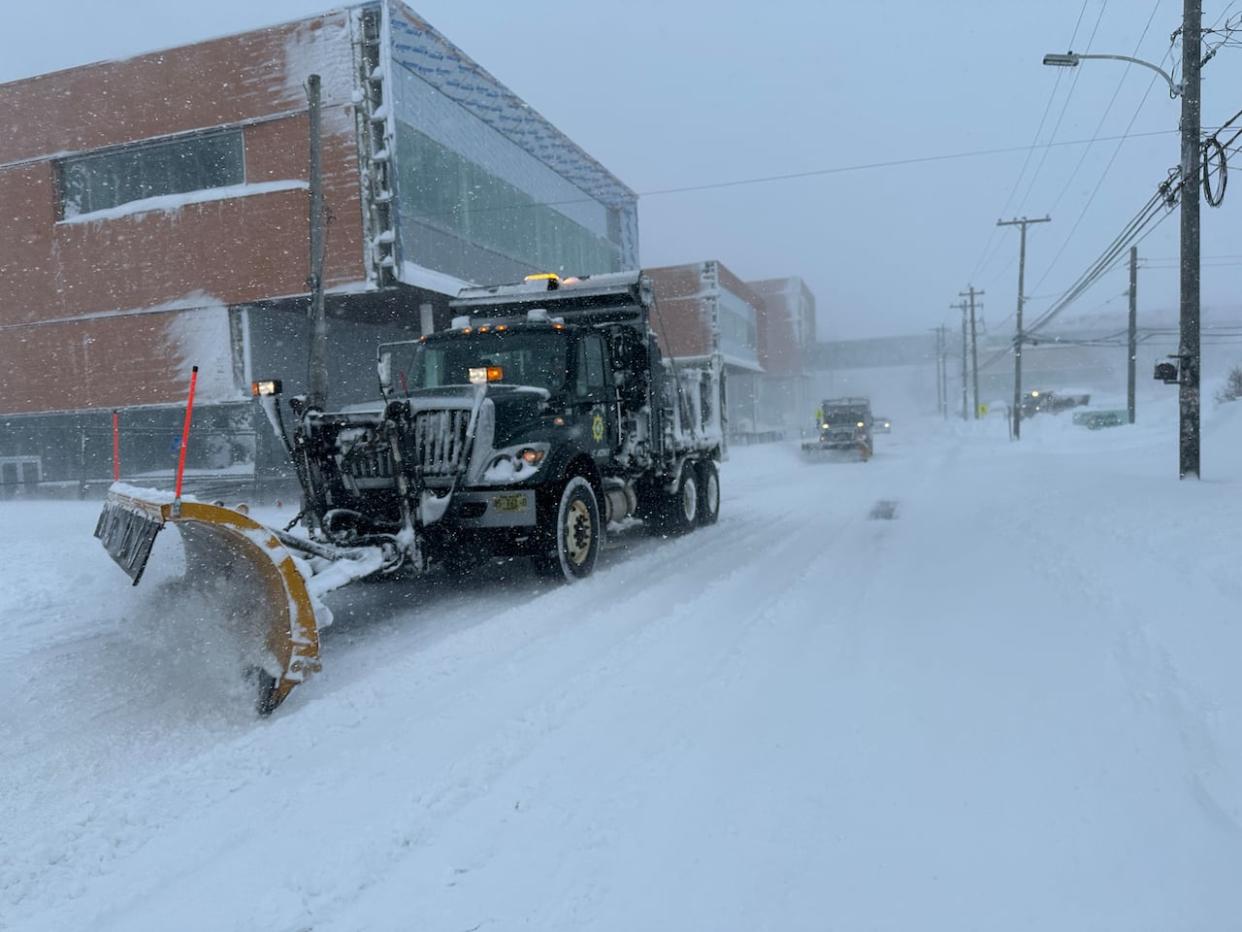 Plows clear snow from the Esplanade in front of the Nova Scotia Community College campus that's under construction in downtown Sydney, N.S., on Sunday, Feb. 4, 2023.  (Tom Ayers/CBC - image credit)