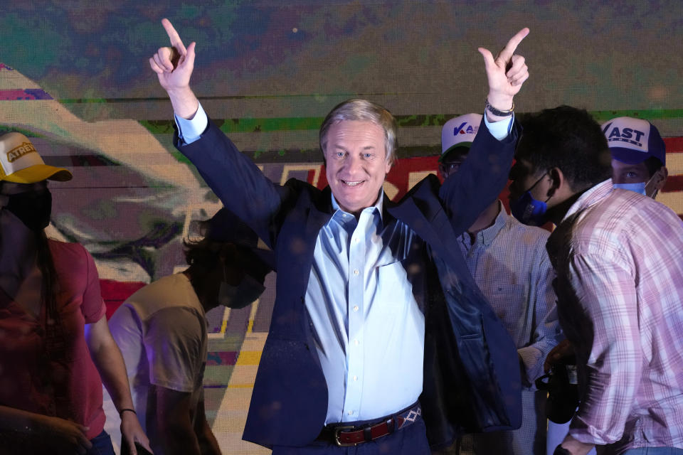 Republican Party presidential candidate Jose Antonio Kast gestures to supporters at his campaign headquarters after polls closed and partial results were announced in Santiago, Chile, Sunday, Nov. 21, 2021. (AP Photo/Esteban Felix)
