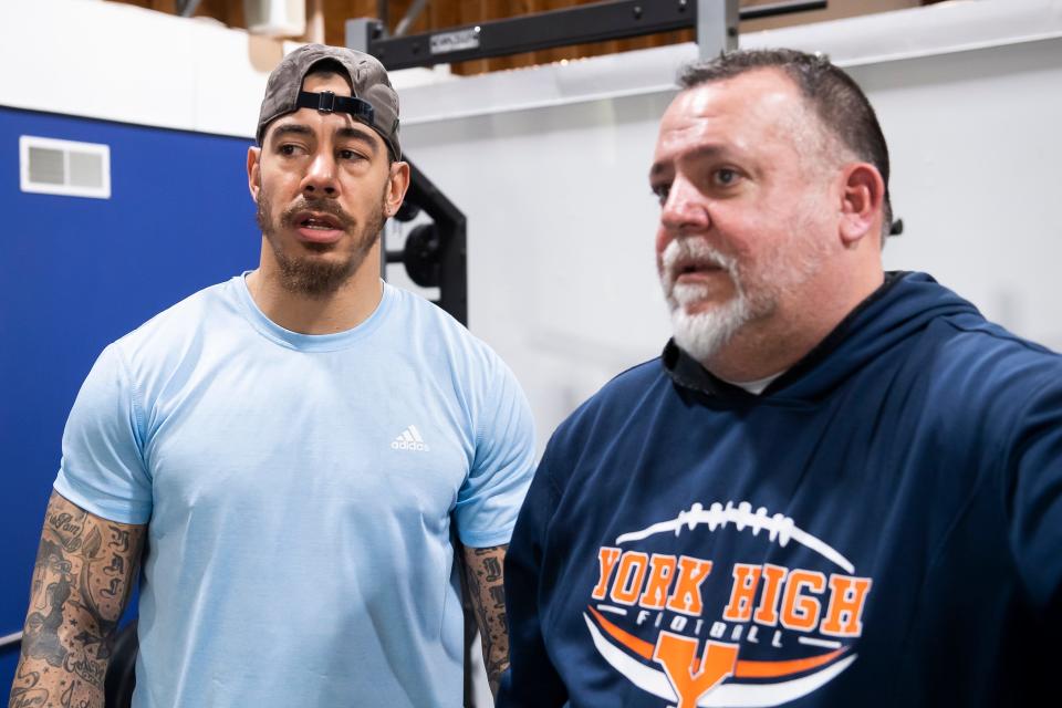 York High football assistant coach Chaz Powell (left) talks with head coach Russ Stoner as they look over a workout session at Accountability for Life's training facility on Feb. 23, 2023, in Manchester Township.