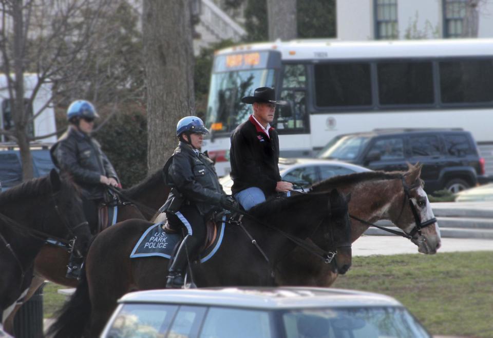 In this photo provided by the Interior Department shows Interior Secretary Ryan Zinke arriving for his first day of work at the Interior Department in Washington, Thursday, March 2, 2017, aboard Tonto, an 17-year-old Irish sport horse. (Interior Department via AP)