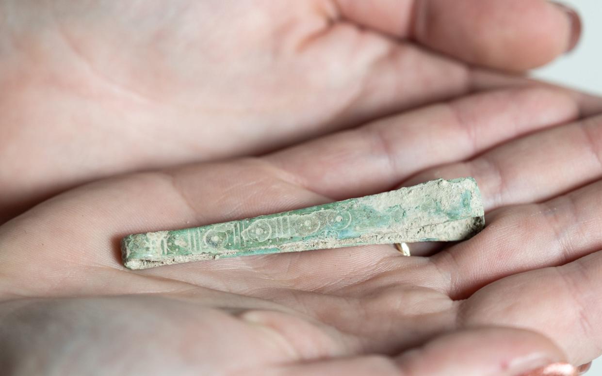 A pair of 5th or 6th century decorated copper alloy tweezers uncovered at a burial site in Wendover - SWNS