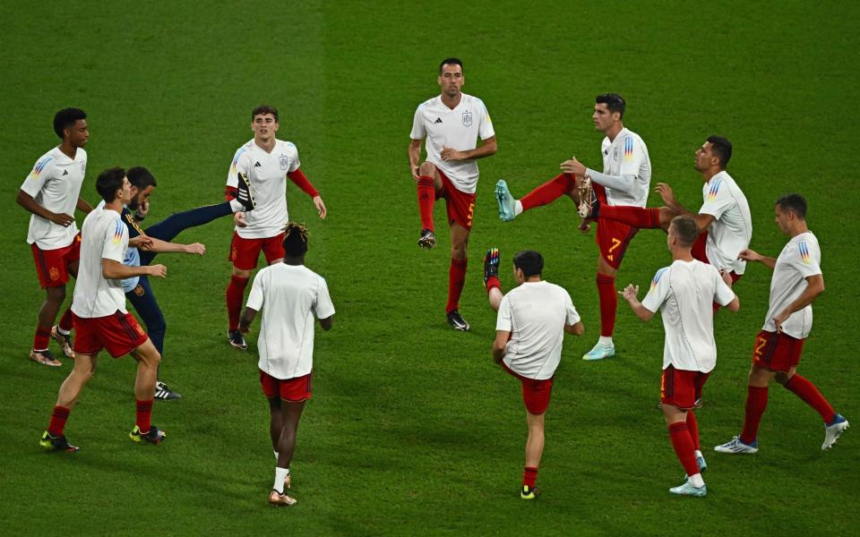 Spain's players warm up prior to the Qatar 2022 World Cup Group E football match - JEWEL SAMAD/AFP