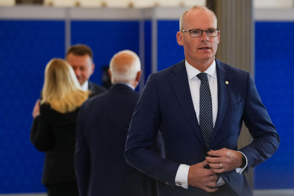 Ireland's Defense Minister Simon Coveney, right, arrives for a meeting of EU Defense Ministers at the Prague Congress Center in Prague, Czech Republic, Tuesday, Aug. 30, 2022. (AP Photo/Petr David Josek)