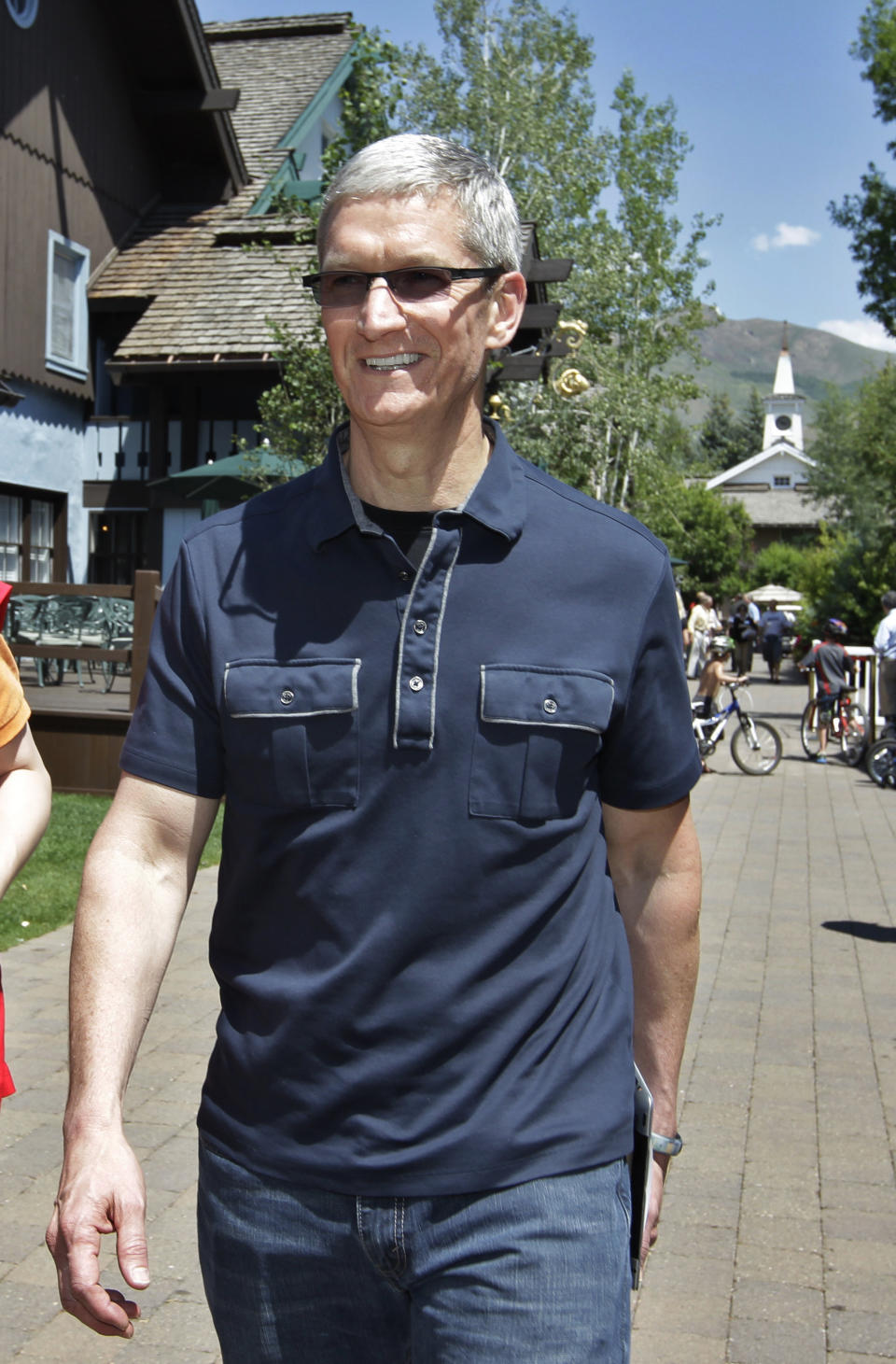 In his Thursday, July 12, 2012 photo, Apple CEO Tim Cook walks to the Allen & Company Sun Valley Conference in Sun Valley, Idaho. Apple Inc. reports quarterly financial results after the market closes on Tuesday, July 24. (AP Photo/Paul Sakuma)