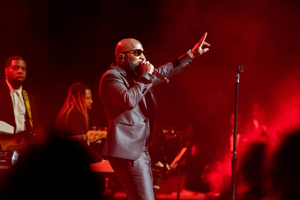 Jeezy performing at his 'Let's Get It: Thug Motivation 101' concert at Atlanta Symphony Hall, wearing a Black suit and Black shades.