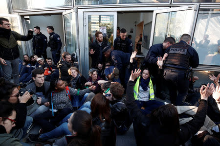 Environmental activists block the entrance of the Ministry of Ecology, Energy and Sustainable Development during a "civil disobedience action" to urge world leaders to act against climate change, in La Defense near Paris, France, April 19, 2019. REUTERS/Benoit Tessier